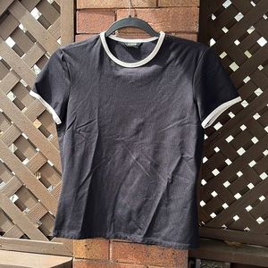 J Crew polyester tee. Black with white trim. No size tag, but it’s a small.